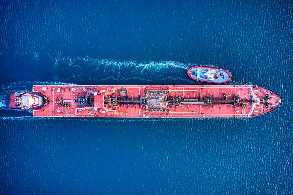 A red oil tanker shot from directly above. 